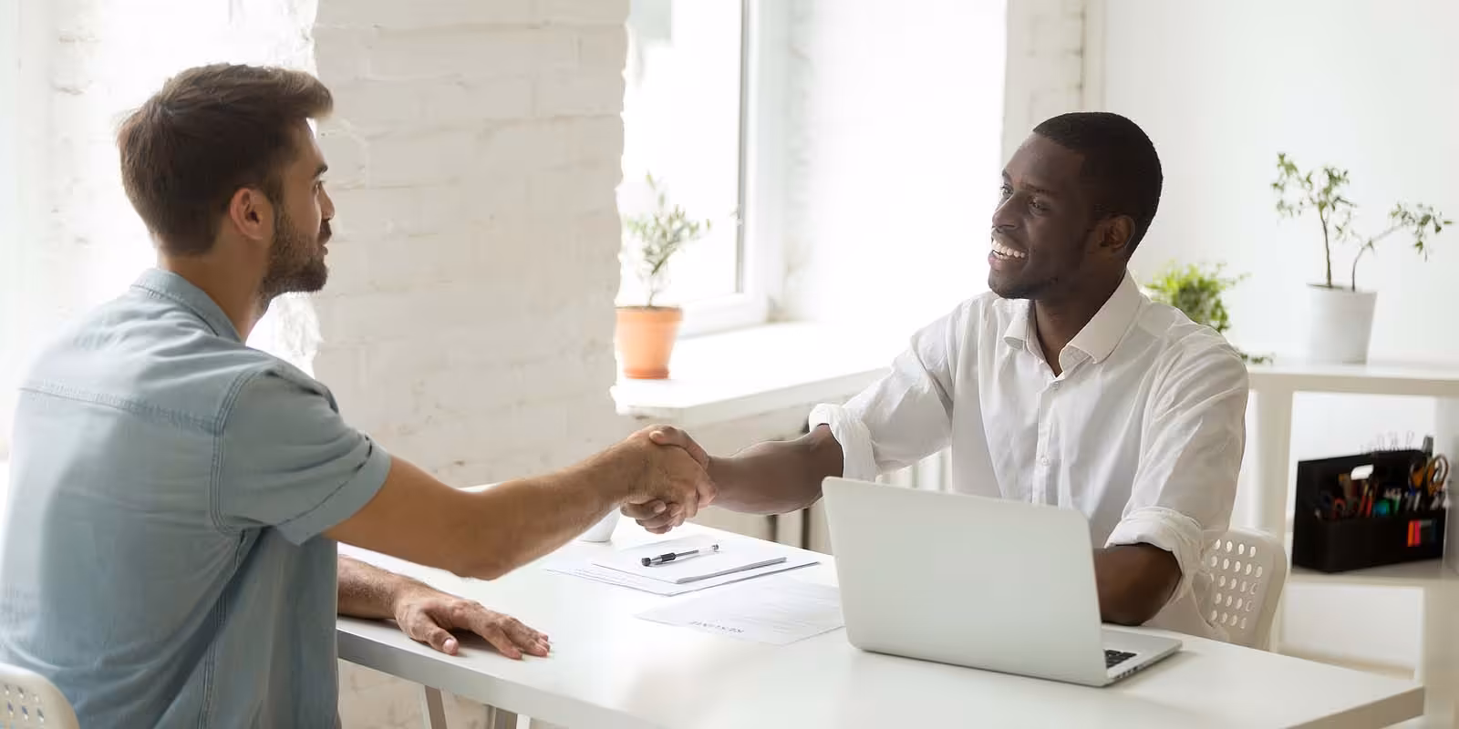 Job applicant getting hired for a job after an interview, shaking hands with the hiring manager fhffbfhfhfhfhfhhf