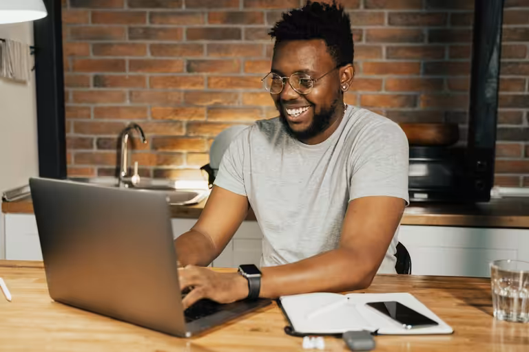 Man typing on his laptop and learning how to find a new job in 2025 using job search tips