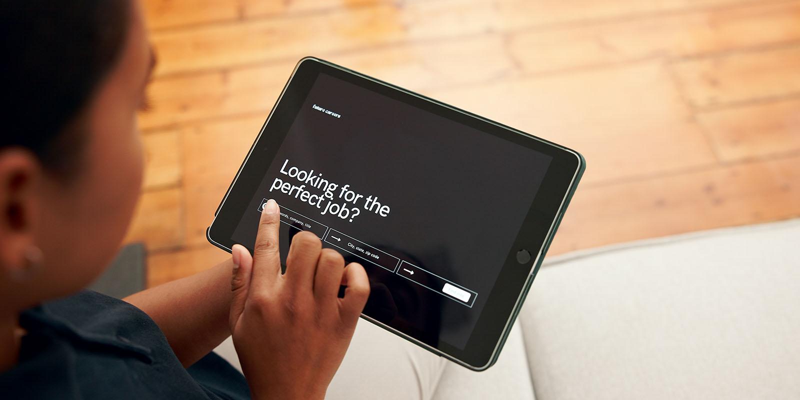 Person using a tablet to look for and apply for jobs online